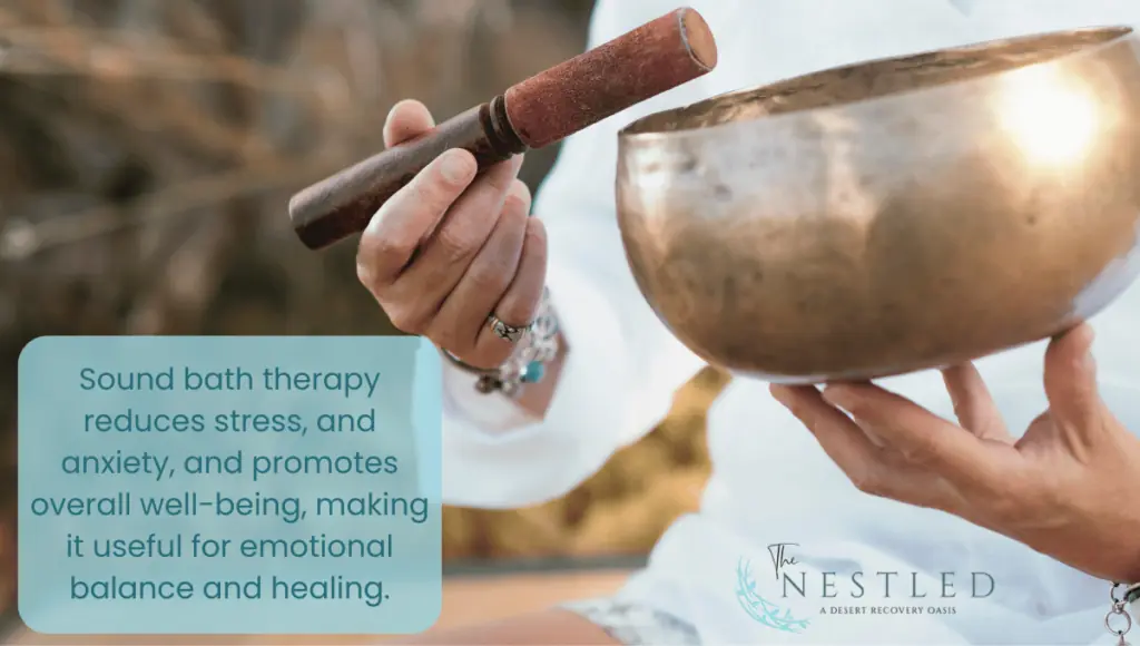 women therapist using small metal sound bowl for a sound bath therapy session.